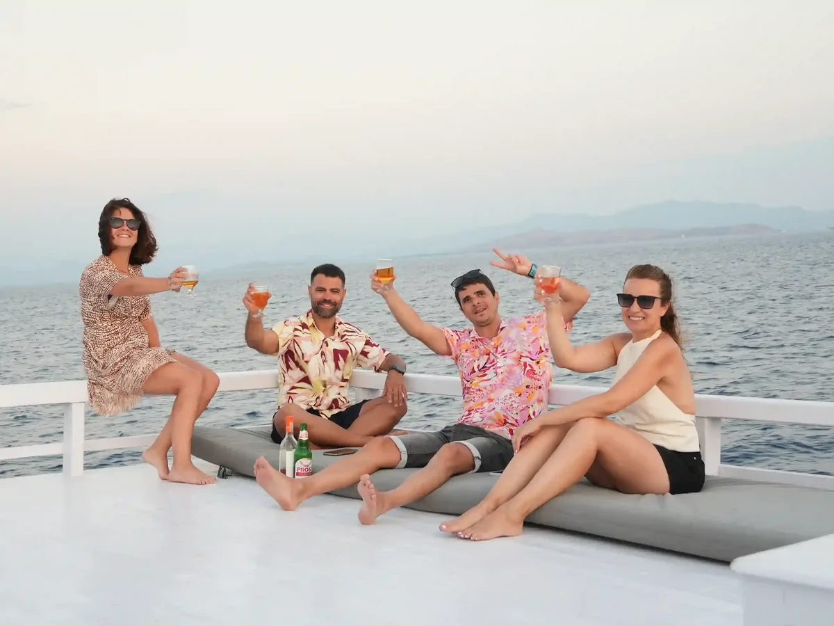 Travellers on the open deck of a phinisi under way